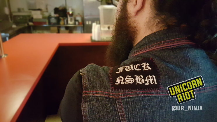 patch on man's back reading FUCK NSBM