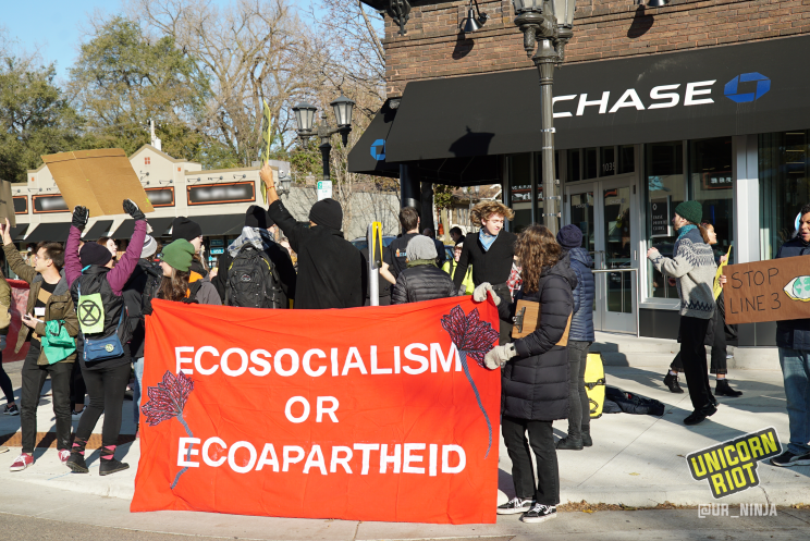 red banner "ecosocialism or ecoapartheid" outside of new Chase Bank branch in St. Paul, MN