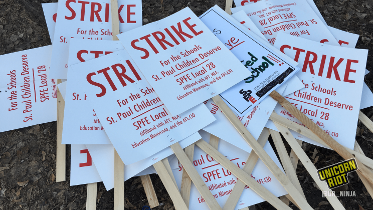 Pile of strike signs from the SPFE Local 28 labor strike. The signs read "Strike For The Schools St. Paul Children Deserve."