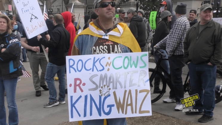 doug malson with sign "rocks n cows r smarter than king walz"
