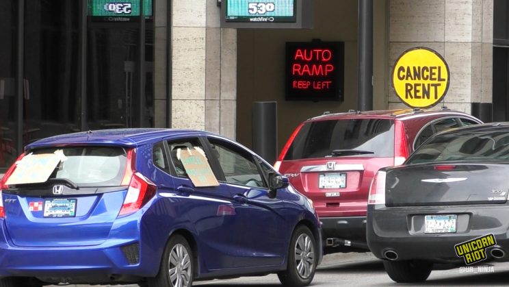 A car with a "cancel rent" sign on it