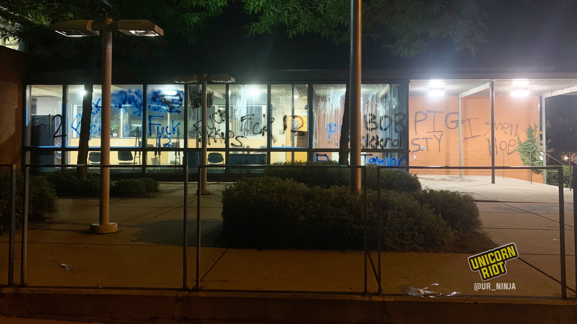 Graffiti on the windows and walls of the 5th Precinct