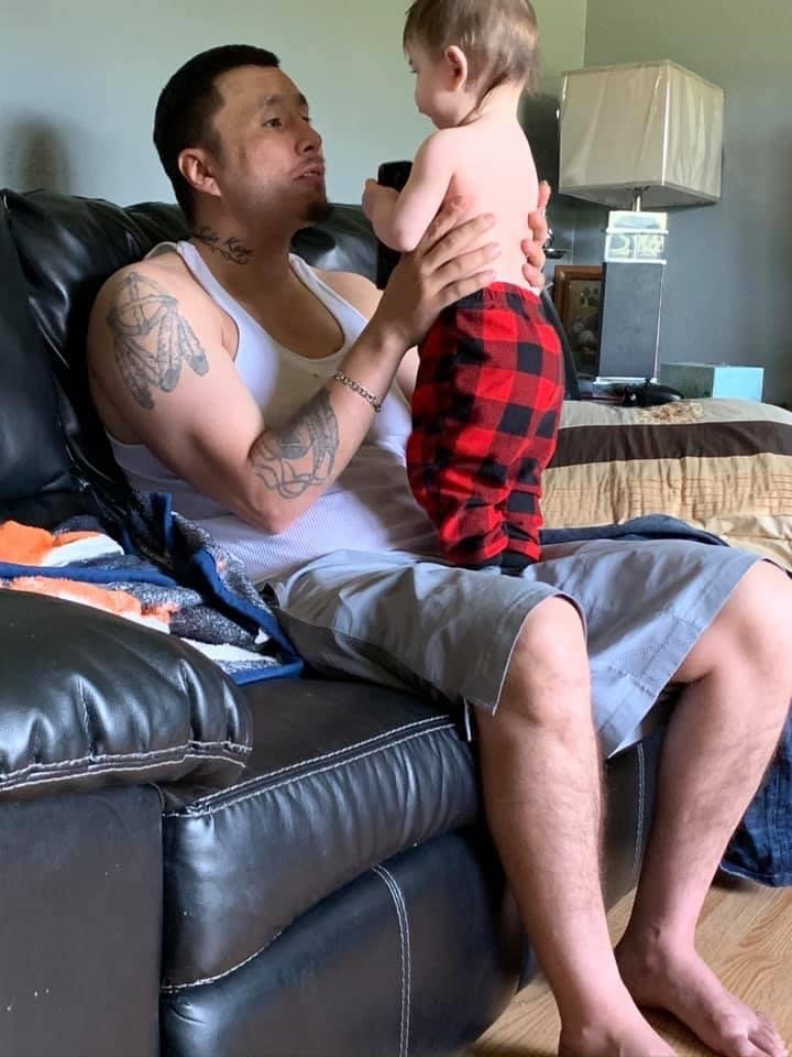 Brandon Laducer, a father of two, holds his nephew.