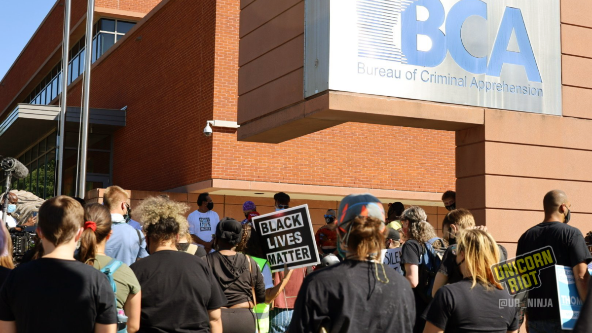 Crowd of people with Black Lives Matter sign outside the Bureau of Criminal Apprehension building.