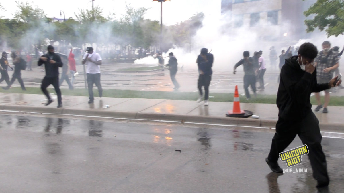 Crowds run away covering their eyes from the CS Gas deployed by Minneapolis Police on May 26, 2020