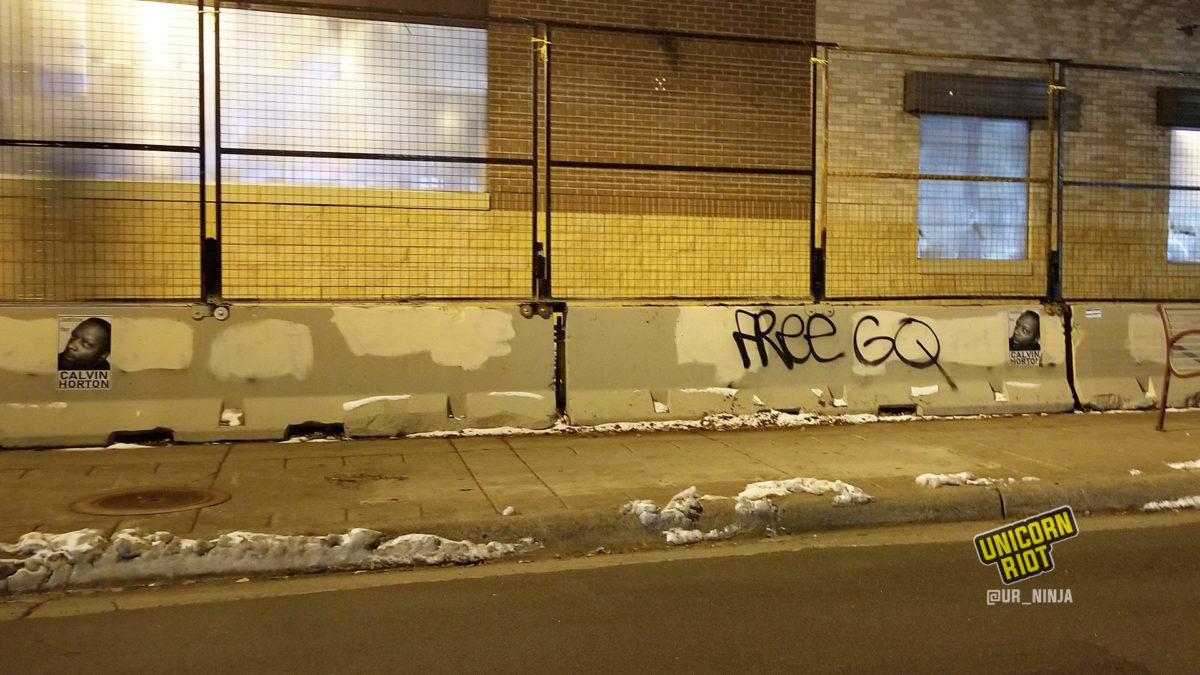 Calvin Horton's image wheatpasted on barricades in front of the 3rd Precinct