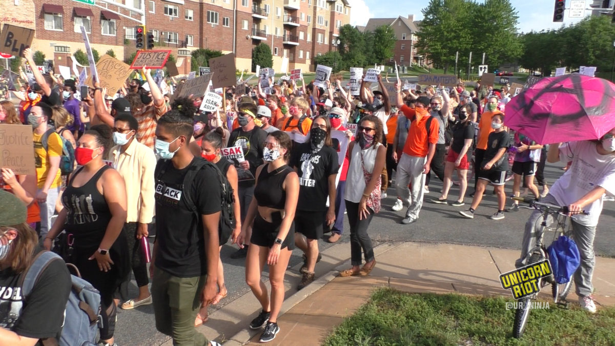 large crowd marches in Eagan for justice for isak aden