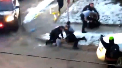minneapolis police kneeling on a person's neck while they hang off the curb with their face into the concrete