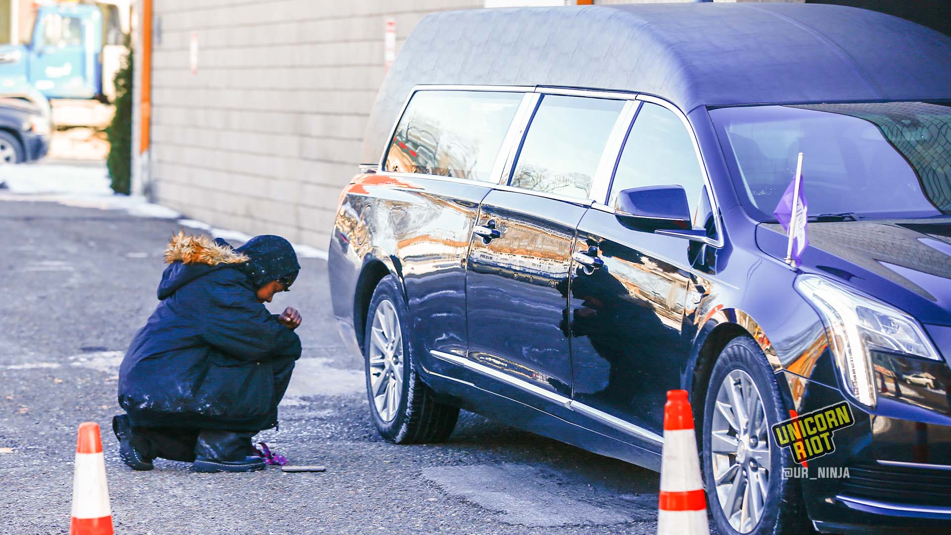 February 17, 2022, Minneapolis, MN: Someone prays outside of the hearse containing the casket with Amir Locke in it before the funeral at Shiloh Temple.