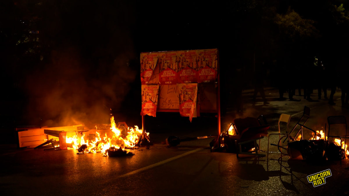 Burning barricades are placed in the street by students on Nov. 17, 2022, during heavy clashes after the main demonstration against the former ruling military junta.