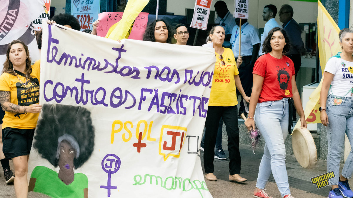 Demonstrators in Ribeirão Preto, Brazil celebrating International Women's Day on March 8, 2023, hold a PSOL (Socialism and Liberty Party) banner reading "Feminists in the fascist downtown streets." Photo contributed by EmiciThug.