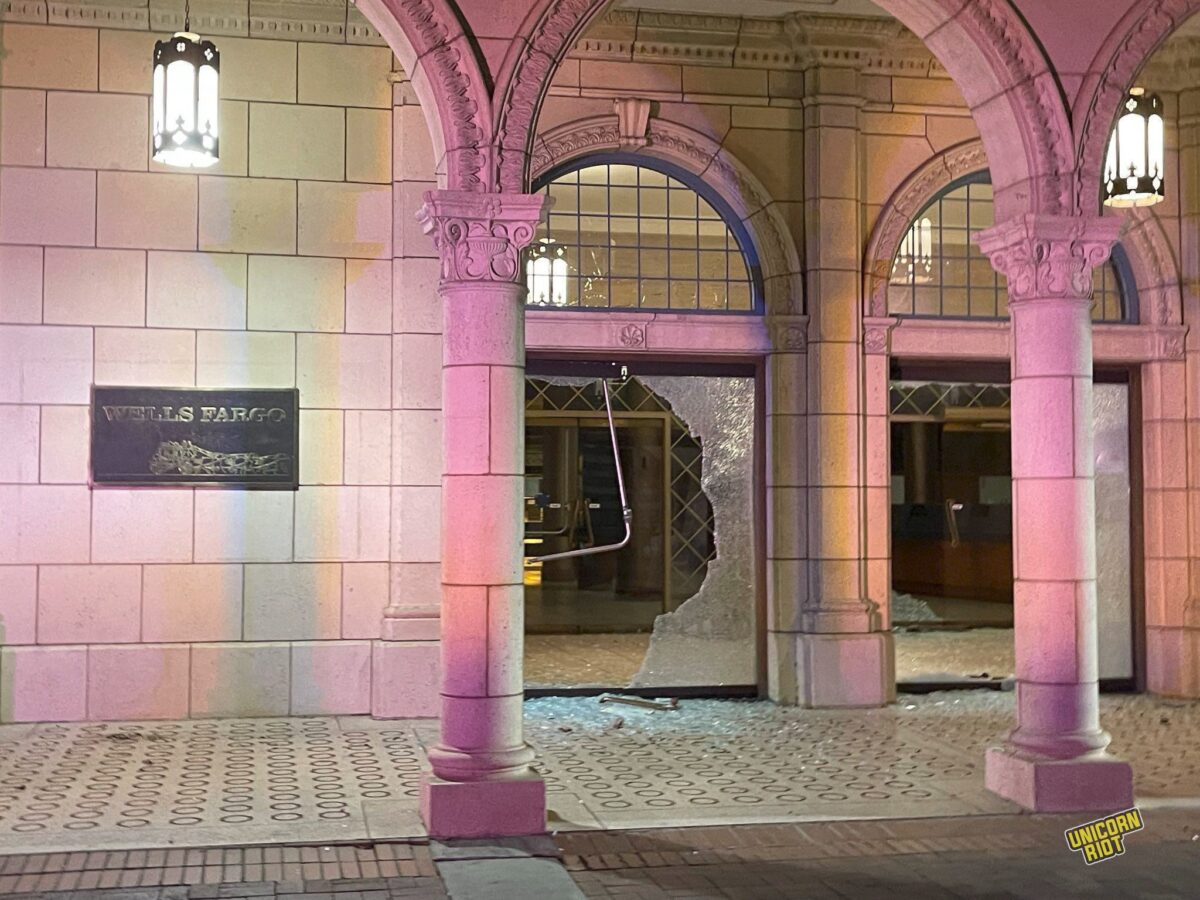 A Wells Fargo location with large windows smashed to shit
